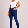 Woman wearing cobalt blue high waist skinny jeans with a clean even wash slim fitted tapered leg and no distressing styled with a white bodysuit and nude strappy heeled sandals against a light grey background