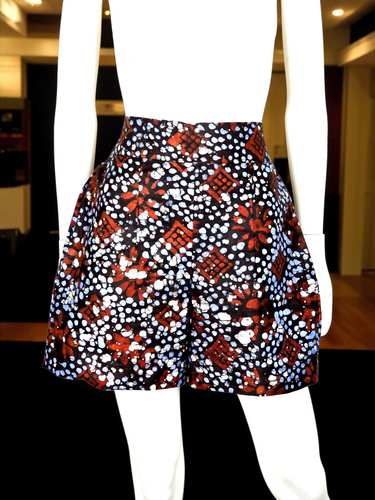 Adire print high-waisted handmade shorts on mannequin with pleated design