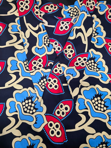 Close-up of a fabric with a colorful floral pattern on a dark background