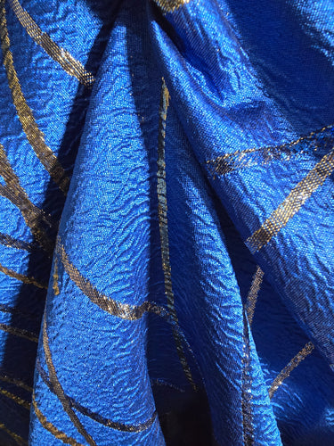 Close-up of blue fabric with gold embroidery