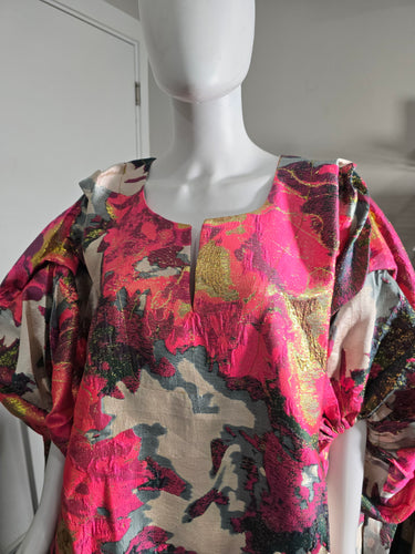 Mannequin wearing a colorful patterned dress with a neutral background
