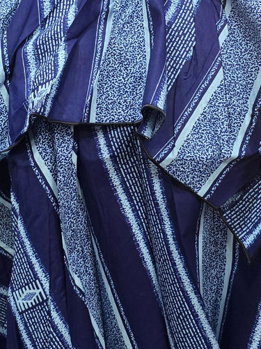 Blue striped dress on a mannequin in a store setting