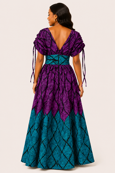 Woman wearing a purple and blue patterned dress on a white background