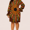 Woman wearing a patterned dress on a plain background