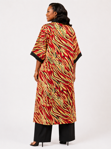 Woman wearing a colorful patterned dress with a white background