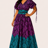 Woman wearing a purple and teal patterned dress on a white background
