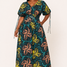 Woman wearing a colorful floral dress on a white background