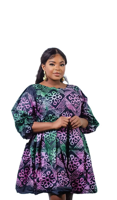 Woman wearing Adire tie-dye short dress with puff sleeves