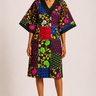 Woman wearing a colorful patterned dress on a plain background