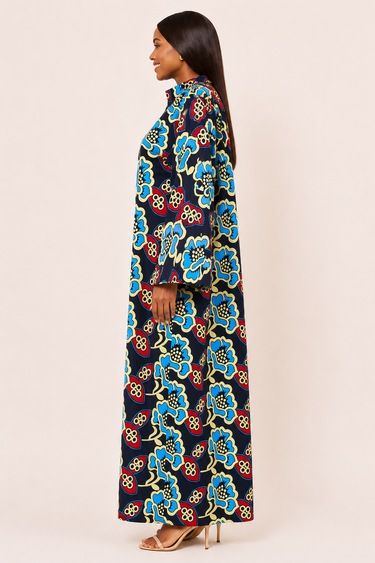 Woman wearing a colorful floral dress on a beige background