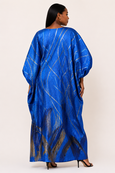 Woman wearing a blue dress with gold patterns on a white background