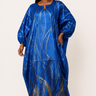 Woman wearing a blue dress with gold patterns on a white background