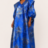 Woman wearing a blue patterned dress on a white background
