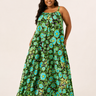 Woman wearing a green floral dress on a beige background