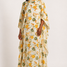 Woman wearing a floral dress with a plain background