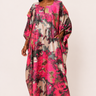 Woman wearing a colorful floral dress on a white background
