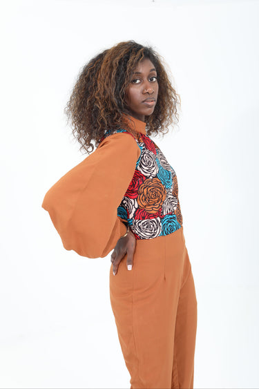Person wearing a patterned top with a white background