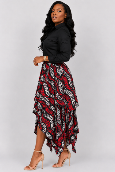 Full length view of a dramatic red and black African print handkerchief skirt with layered uneven ruffle tiers and high waist fit in a bold wave and dot Ankara print fabric