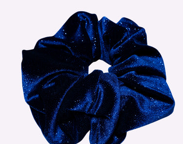 Blue glittery scrunchie on a light gray background