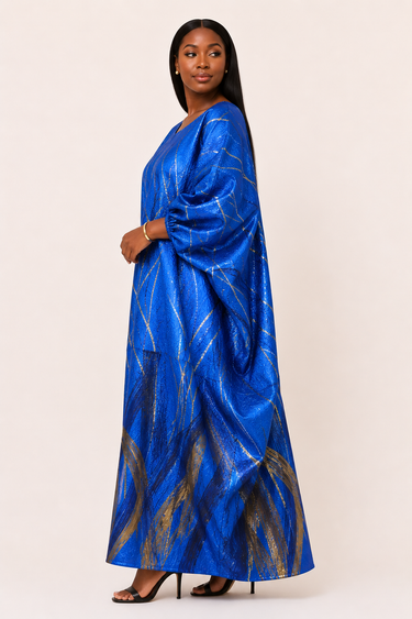 Woman wearing a blue dress with gold patterns on a white background