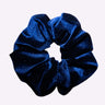 Blue glittery scrunchie on a white background