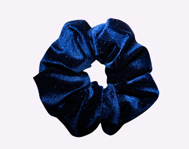 Blue glittery scrunchie on a white background
