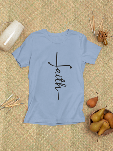 Flat lay of religious faith t-shirt styled with rustic props